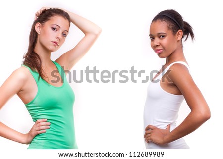 portrait of two different nationalities teenage girls friends - isolated on white background