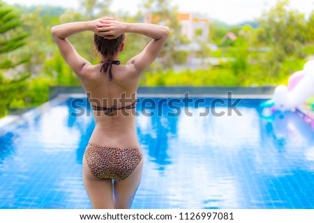 woman in big hat relaxing on the swimming pool. Summer concept