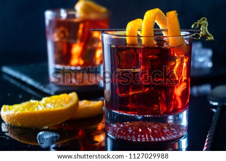Negroni Cocktail with Orange Twist and Pin, on Dark Background. Beverage Photography. Royalty-Free Stock Photo #1127029988