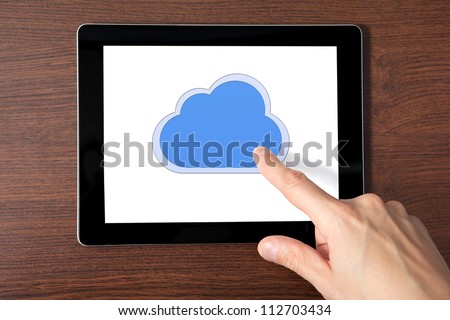 man hand holding a tablet touch computer gadget with the image of cloud