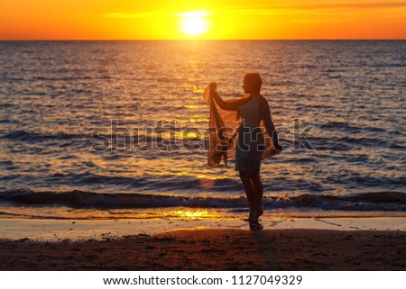 girl walking by the sea at sunset vacation concept