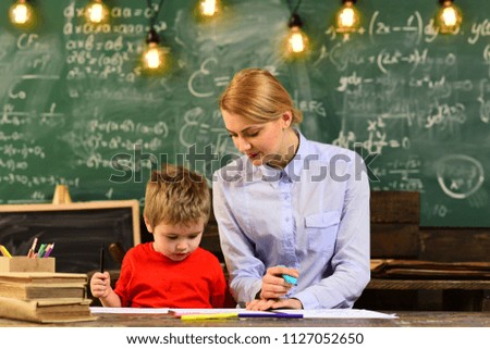 Teacher is warm accessible enthusiastic and caring, Mature tutor teacher giving private lessons to preschool boy, Teacher or tutor helps preschool child,