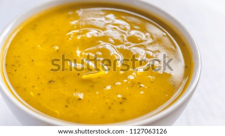 Close of white bowl with cabotiá pumpkin soup