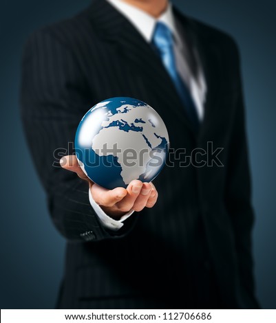 Businessman holds Earth in a hand