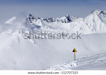 Warning sing on ski slope. Caucasus Mountains, Georgia, ski resort Gudauri