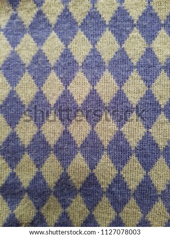 Background of blue knitted seamless pattern, close up