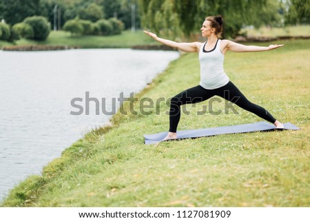 Young girl doing yoga in morning park.Woman Yoga - relax in nature