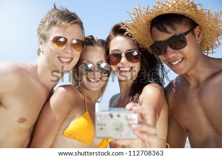 group of young people taking a photograph