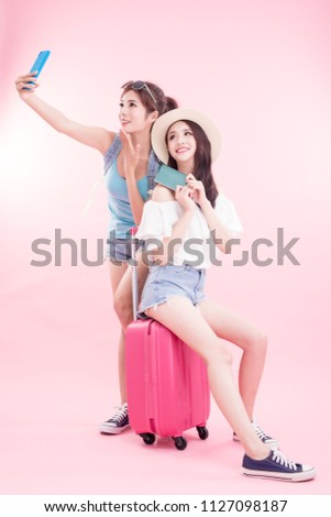 two beauty woman selfie happily with travel concept on the pink background