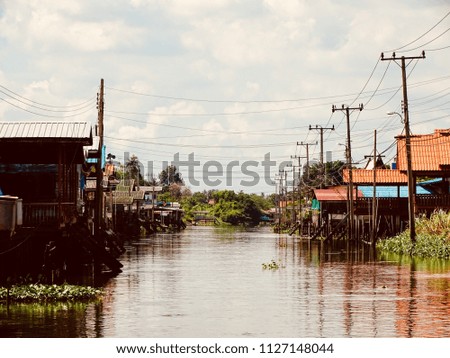 Landscape view of Countryside houses at the riverside. City dwellers live along canals in Asia. Picture of the peaceful village along the canal.