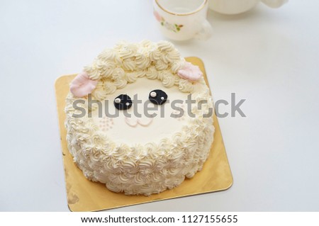 A sheep Birthday cakes with afternoon tea set on white background