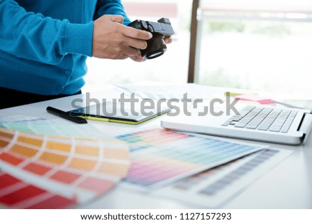 Graphic designer and Photographer working on computer and used graphics tablet.
