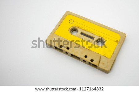 close up of old and dirty vintage audio tape cassette isolated on white background