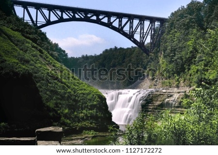 Landscape photo of Upper waterfall in Letchworth State Park, State New York,USA. The bridge is over the waterfall.