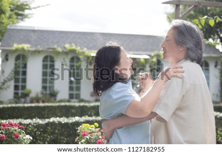 senior asian female dancing with asian senior Male on garden background, love forever, retirement lifestyle