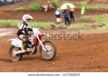 Abstract blur a  motocross rider in motocross race background.