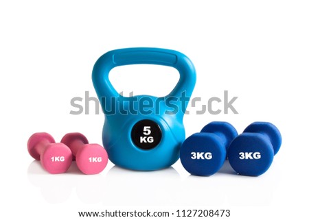 Kettlebell and dumbbells for weights training isolated on a white background.