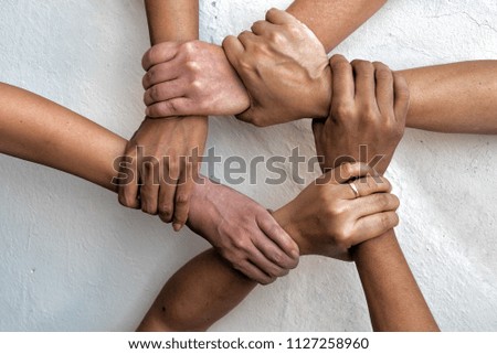 Group of young business people united, joining , combine hands together expressing positive, unity, volunteer , teamwork concepts. Royalty-Free Stock Photo #1127258960