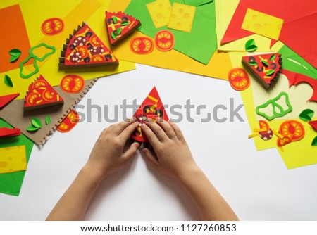 Girl makes paper crafts pizza. Child's hand. Master class. Favorite hobby. Creativity with kids school and kindergarten.
