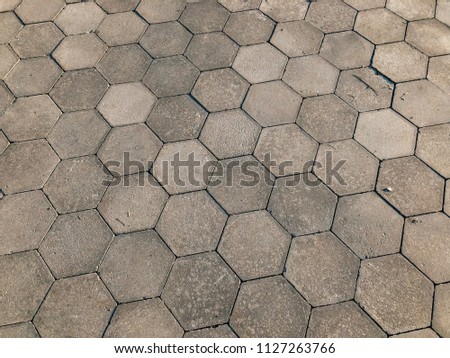 Stone pavement in perspective. Stone pavement texture. Granite cobblestoned pavement background. Abstract background of a cobblestone pavement