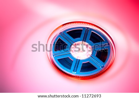 Pink red blue color film reel - concept background. Movie industry symbol.