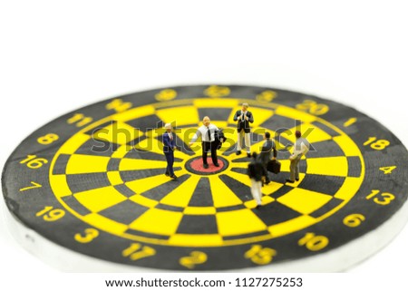 Miniature people : leader and business owner,boss at the target on dart board, concept of success.