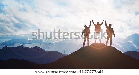 Silhouette of the team on the mountain. Leadership Concept Royalty-Free Stock Photo #1127277641