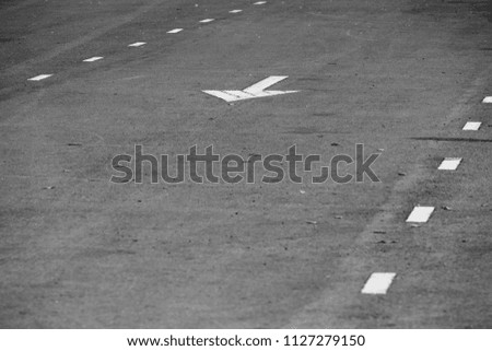 asphalt road and arrow sign with copy space