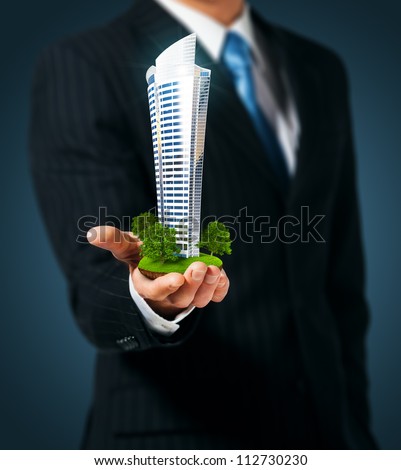 Man holding a skyscraper  in hand