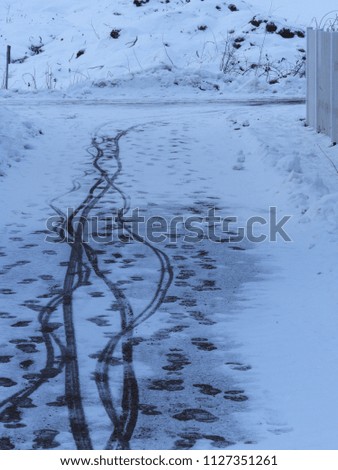 A winter road with some footprints