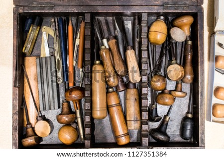 Antique tools for engraving and printing in a wooden case. Tools for typographers and artists to make prints, lithographs, etchings and engravings. Ancient art and craftsmanship