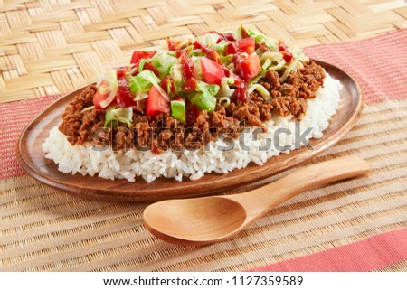 Rice Topped with a Taco Filling Royalty-Free Stock Photo #1127359589