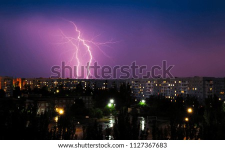 Lightning strikes down over the city at night. Beautiful shot. Long Exposure Photography