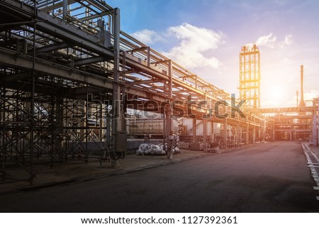 Pipeline and pipe rack of petroleum industrial plant with sunset sky background Royalty-Free Stock Photo #1127392361