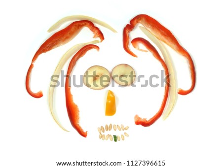 Rasta man face made with various raw vegetables, an emoticon on white background