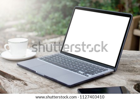 Mock up image of laptop computer with blank white screen,  mobile smart phone and a cup of coffee on the wooden table, mock up design for advertising. vintage style. clipping path.