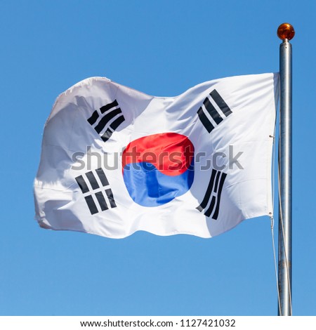 Flag of South Korea, also known as the Taegukgi waving on a flagpole