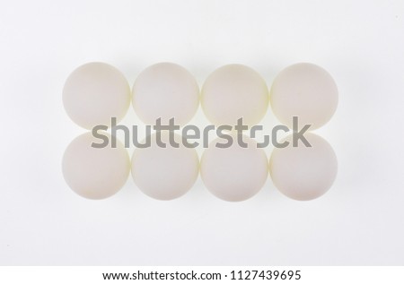 white abstract balls, eggs, geometric shapes, white background