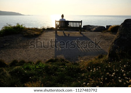 girl with bench and ocean view