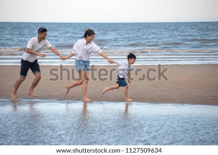 Happy family on the beach. Parents with Children enjoying a holiday at the sea. Summer vacation concept