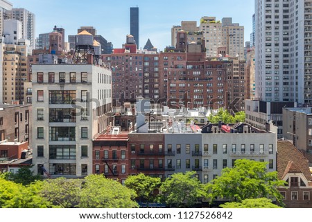 New York City - Overhead view of historic buildings along 59th Street with the Midtown Manhattan skyline in the background