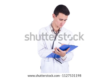 Handsome doctor wearing his coat and stethoscope holding a pen and a paper, writing a description, isolated on white background