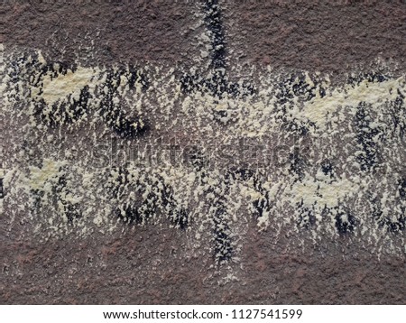 dark rough surface with spots of paint