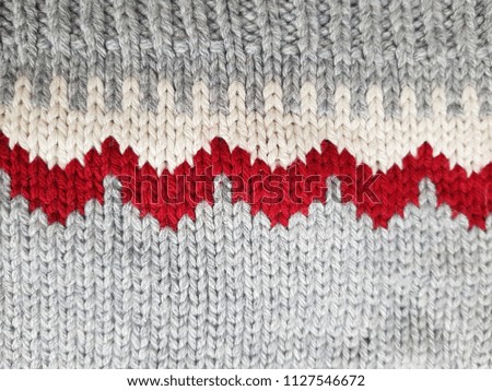 Sweater or scarf fabric texture large knitting. Knitted jersey background with a relief pattern. Wool hand - machine, handmade