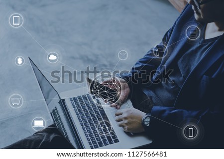 Man holding smart phone and laptop making online shopping and banking payment.
