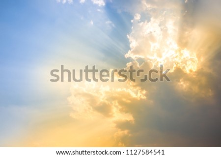 Beautiful bright orange - yellow cloudy sky during the sunrise and sunset. Beautiful scenic gradient sky between hot and cool tone of twilight sky with a cloud. Sun beam background. Royalty-Free Stock Photo #1127584541