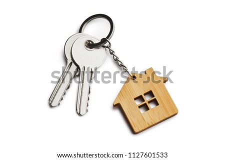 House keys with house shaped keychain, isolated on white background Royalty-Free Stock Photo #1127601533