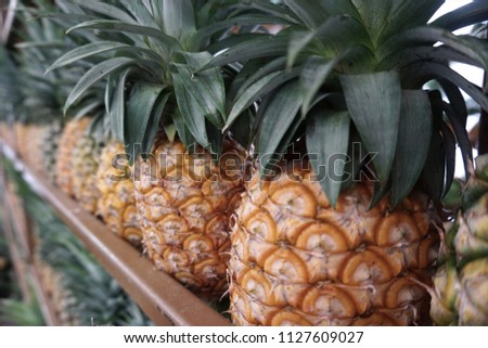 Pineapple is a large juicy tropical fruit consisting of aromatic edible yellow flesh surrounded by a tough segmented skin and topped with a tuft of stiff leaves. It is rich in vitamins.
