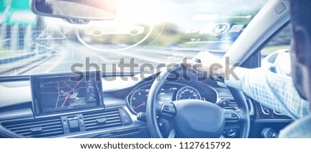 Digital image of cars and tools against close-up of man driving 