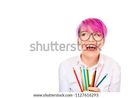 Funny excited young woman holding crayon pencils isolated white wall background. Free thinking new approach, Creativity, imagination, dynamism, intelligence concept. Crazy graphic designer concept.